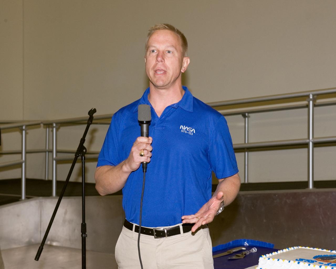 JSC2010-E-164858 (20 Sept. 2010) --- NASA astronaut Tim Kopra, STS-133 mission specialist, speaks to a crowd during a cake-cutting ceremony in the Jake Garn Simulation and Training Facility at NASA's Johnson Space Center. Photo credit: NASA or National Aeronautics and Space Administration