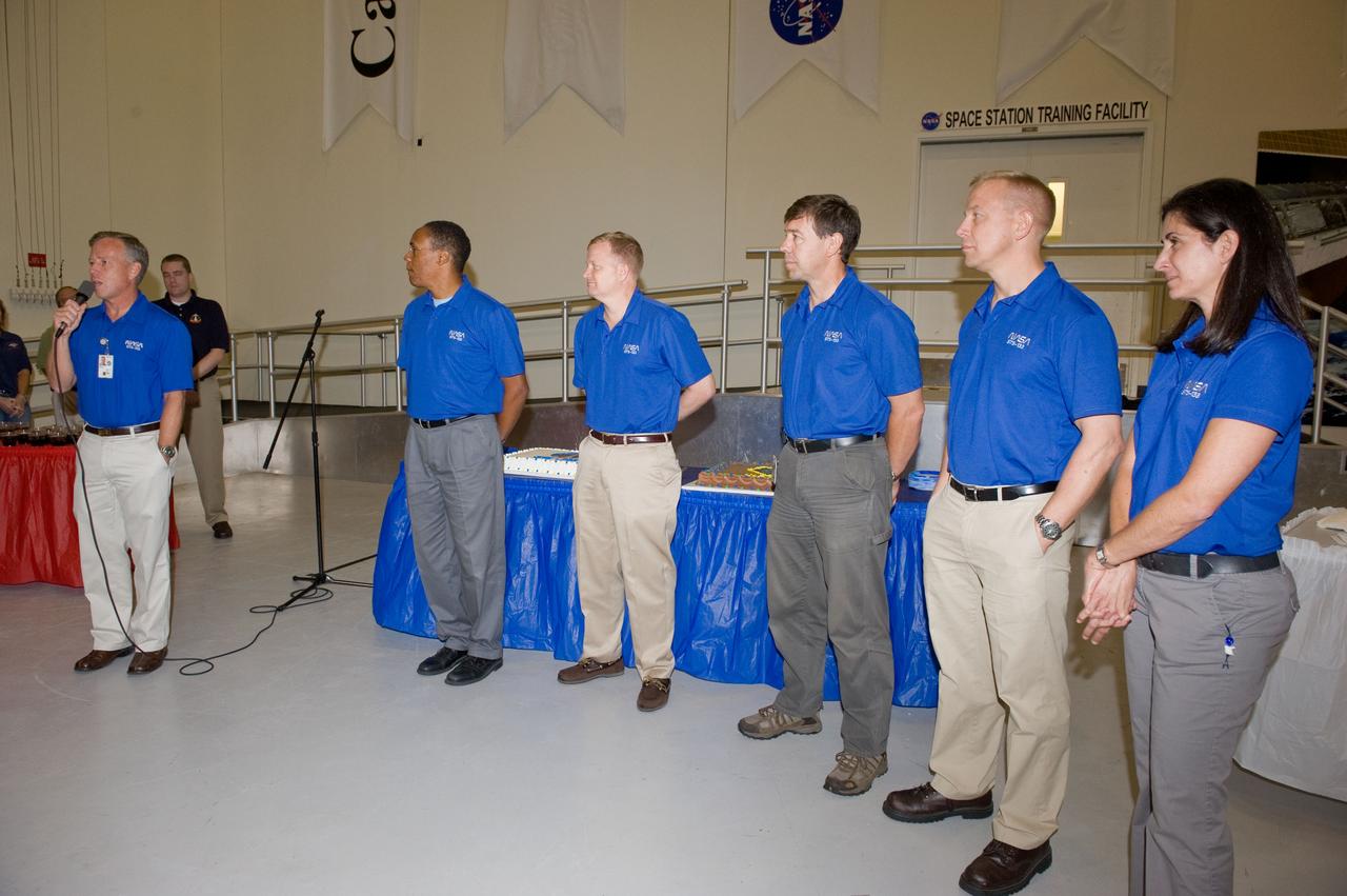 JSC2010-E-164862 (20 Sept. 2010) --- NASA astronaut Steve Lindsey (far left), STS-133 commander, speaks to a crowd during a cake-cutting ceremony in the Jake Garn Simulation and Training Facility at NASA's Johnson Space Center. Also pictured (from second left) are NASA astronauts Alvin Drew, mission specialist; Eric Boe, pilot; Michael Barratt, Tim Kopra and Nicole Stott, all mission specialists. Photo credit: NASA or National Aeronautics and Space Administration