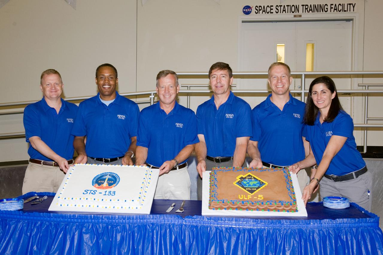 JSC2010-E-164863 (20 Sept. 2010) --- STS-133 crew members pose for a photo during a cake-cutting ceremony in the Jake Garn Simulation and Training Facility at NASA's Johnson Space Center. Pictured from the left are NASA astronauts Eric Boe, pilot; Alvin Drew, mission specialist; Steve Lindsey, commander; Michael Barratt, Tim Kopra and Nicole Stott, all mission specialists. Photo credit: NASA or National Aeronautics and Space Administration