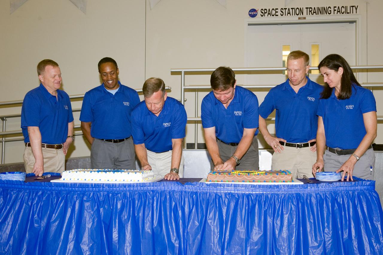 JSC2010-E-164865 (20 Sept. 2010) --- STS-133 crew members are pictured during a cake-cutting ceremony in the Jake Garn Simulation and Training Facility at NASA's Johnson Space Center. Pictured from the left are NASA astronauts Eric Boe, pilot; Alvin Drew, mission specialist; Steve Lindsey, commander; Michael Barratt, Tim Kopra and Nicole Stott, all mission specialists. Photo credit: NASA or National Aeronautics and Space Administration