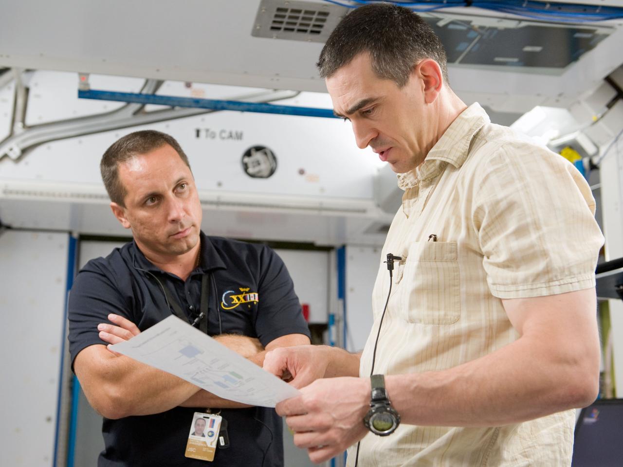 PHOTO DATE: 09-20-10 LOCATION: Bldg 9NW, ISS Mockups SUBJECT:  Expedition 29 crew members Dan Burbank, Anton Shkaplerov and Anatoly Ivanishin during Routine Ops MS02 training with instructor Bill Frank. PHOTOGRAPHER: James Blair