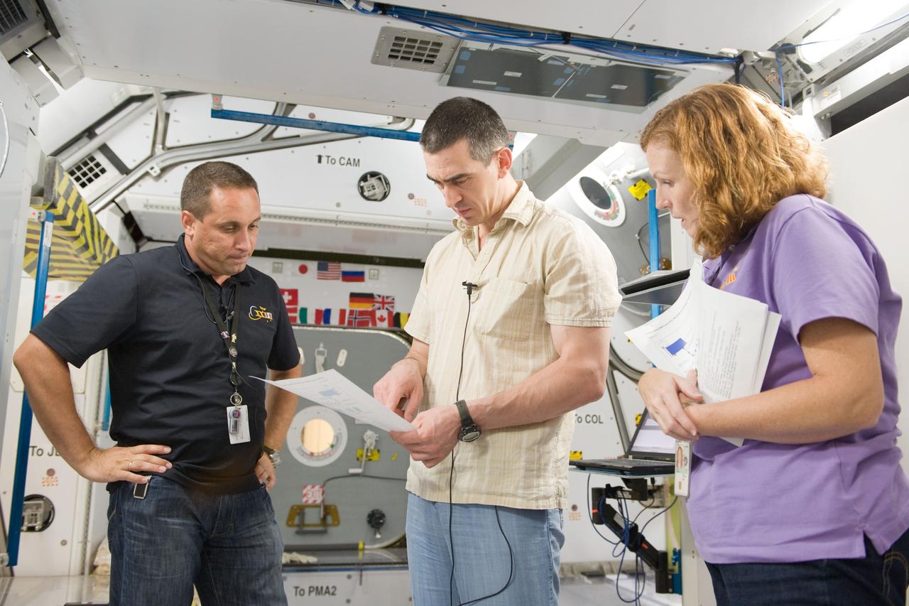 PHOTO DATE: 09-20-10 LOCATION: Bldg 9NW, ISS Mockups SUBJECT:  Expedition 29 crew members Dan Burbank, Anton Shkaplerov and Anatoly Ivanishin during Routine Ops MS02 training with instructor Bill Frank. PHOTOGRAPHER: James Blair