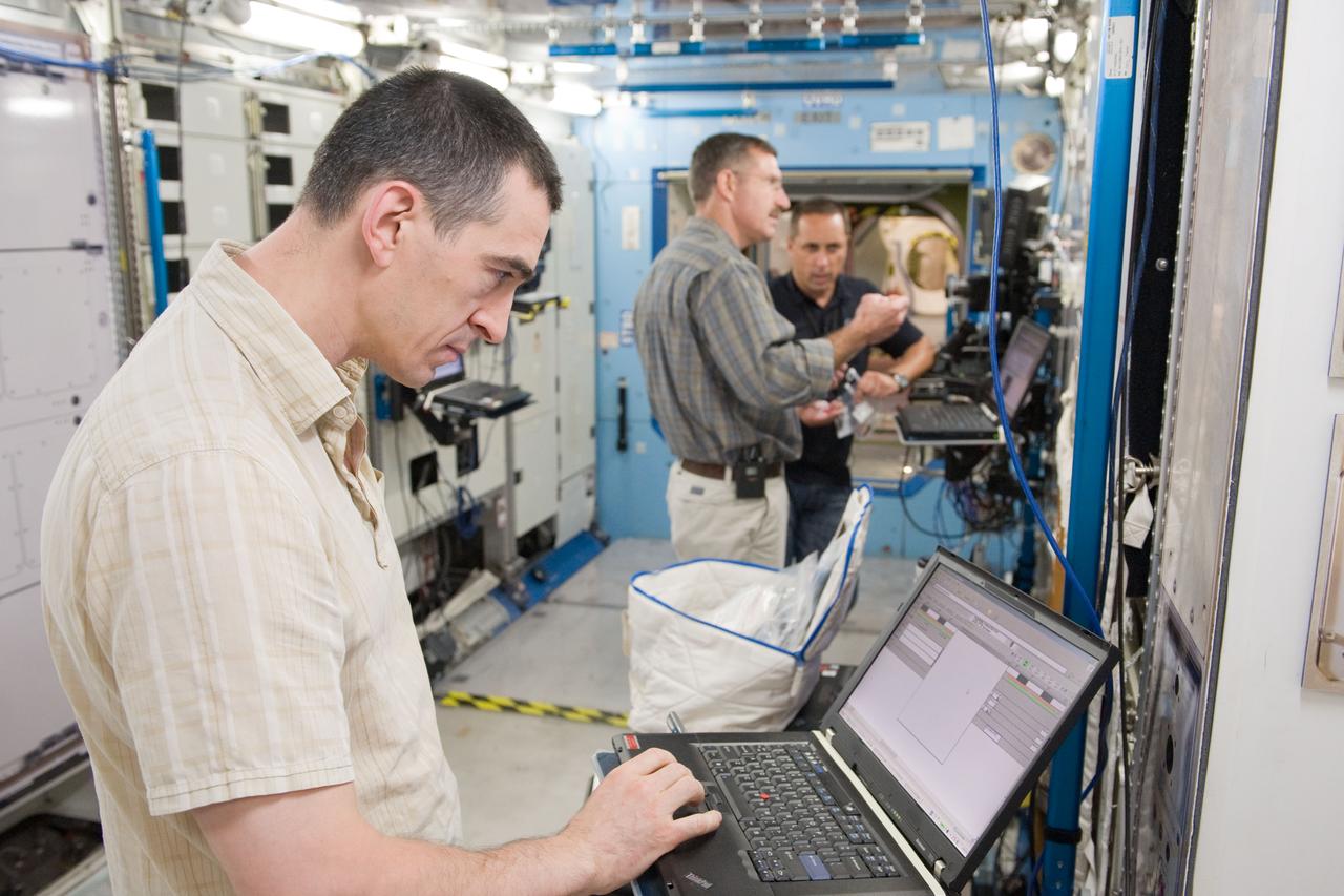 PHOTO DATE: 09-20-10 LOCATION: Bldg 9NW, ISS Mockups SUBJECT:  Expedition 29 crew members Dan Burbank, Anton Shkaplerov and Anatoly Ivanishin during Routine Ops MS02 training with instructor Bill Frank. PHOTOGRAPHER: James Blair
