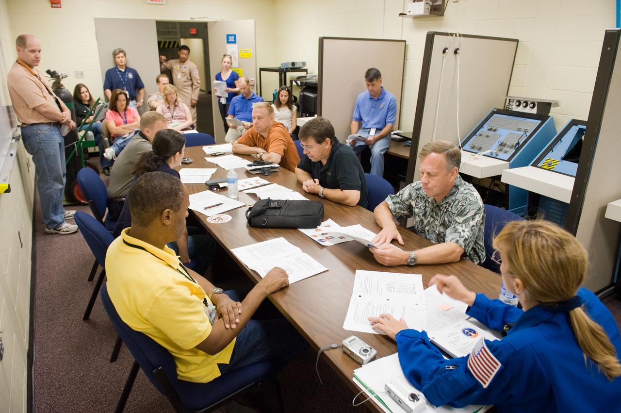 JSC2010-E-166818 (24 Sept. 2010) --- STS-133 crew members are pictured in a classroom setting during a training session in the Space Vehicle Mock-up Facility at NASA's Johnson Space Center. Pictured counter-clockwise (from the right) are NASA astronauts Steve Lindsey, commander; Michael Barratt, Tim Kopra, both mission specialists; Eric Boe, pilot; Nicole Stott and Alvin Drew, both mission specialists. Photo credit: NASA or National Aeronautics and Space Administration