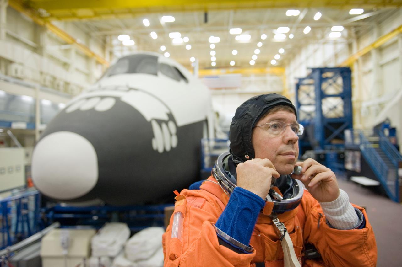 JSC2010-E-166825 (24 Sept. 2010) --- NASA astronaut Michael Barratt, STS-133 mission specialist, dons a training version of his shuttle launch and entry suit in preparation for a training session in the Space Vehicle Mock-up Facility at NASA's Johnson Space Center. Photo credit: NASA or National Aeronautics and Space Administration