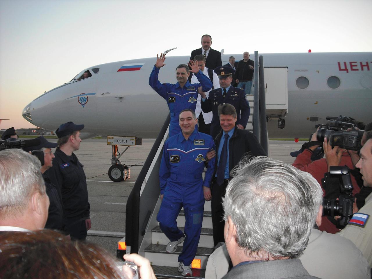 At Chkalovsky Airbase outside Star City, Russia, Expedition 24 Commander Alexander Skvortsov (foreground) and Flight Engineer Mikhail Kornienko (arms raised) descend from the plane that flew them from Karaganda, Kazakhstan back to their training base at the Gagarin Cosmonaut Training Center September 25, 2010, just hours after returning to Earth in the Soyuz TMA-18 spacecraft to wrap up 176 days in space, 174 days on the International Space Station. Their crewmate, Tracy Caldwell Dyson, who landed with them, flew home on a NASA plane to the Johnson Space Center.  Credit: NASA/Jeremiah Maddix 