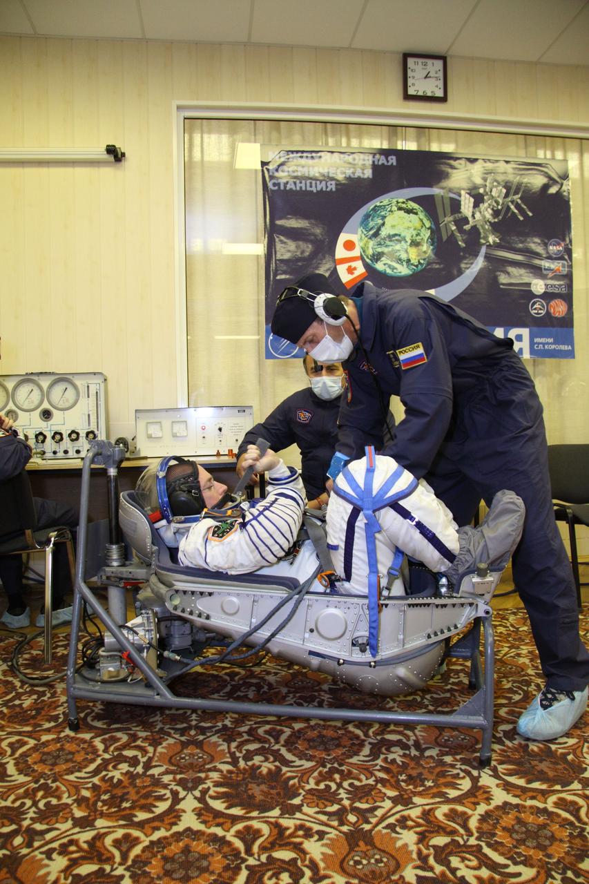 At the Baikonur Cosmodrome in Kazakhstan, Expedition 25 Flight Engineer Scott Kelly of NASA undergoes leak checks to his Sokol launch and entry suit September 26, 2010 as he and Flight Engineers Alexander Kaleri and Oleg Skripochka prepare for their launch October 8 in the Soyuz TMA-01M spacecraft to the International Space Station.  Credit: NASA/Victor Zelentsov 