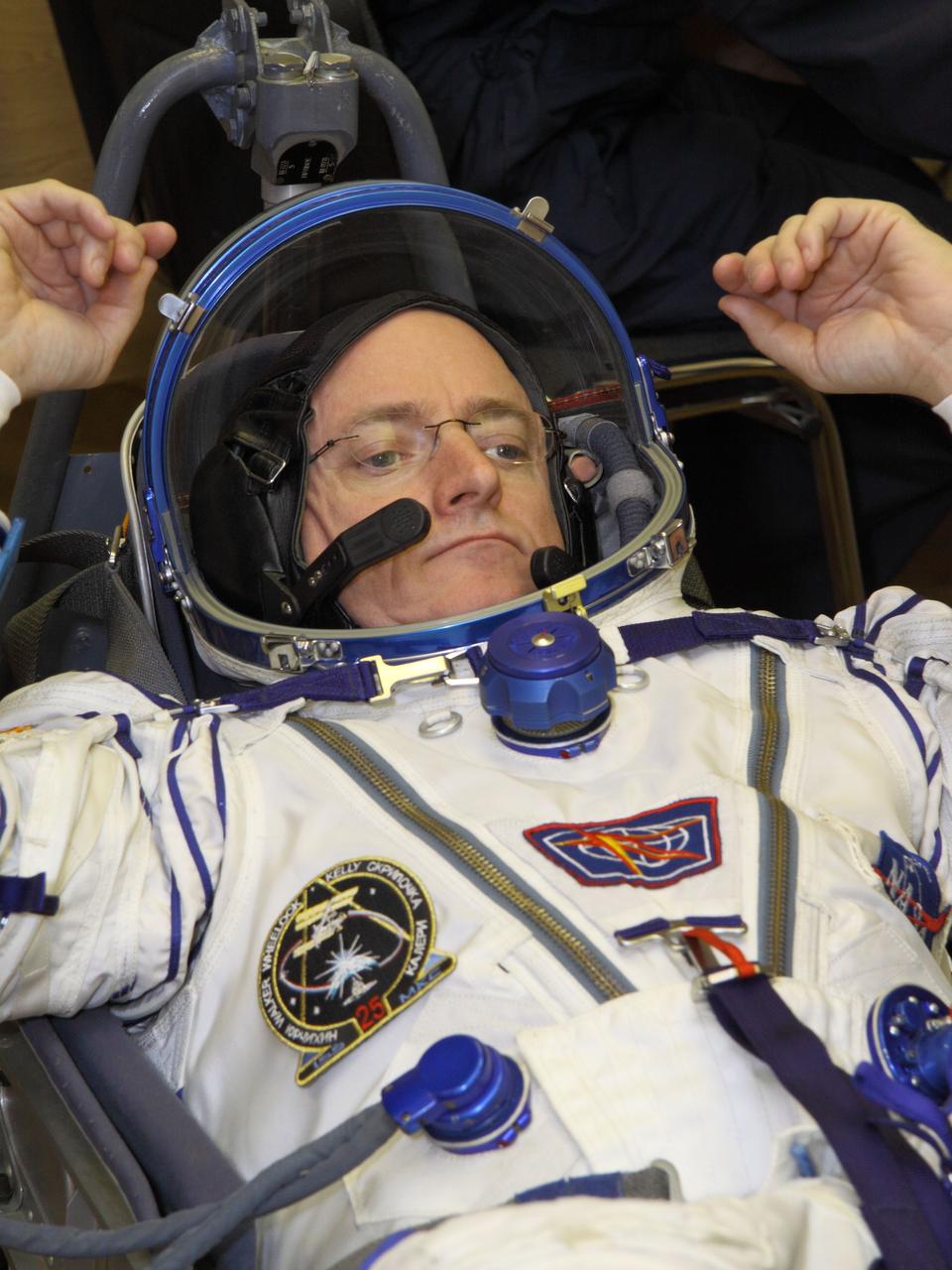 At the Baikonur Cosmodrome in Kazakhstan, Expedition 25 Flight Engineer Scott Kelly of NASA checks his Sokol launch and entry suit September 26, 2010 as he and Flight Engineers Alexander Kaleri and Oleg Skripochka prepare for their launch October 8 in the Soyuz TMA-01M spacecraft to the International Space Station.  Credit: NASA/Victor Zelentsov 