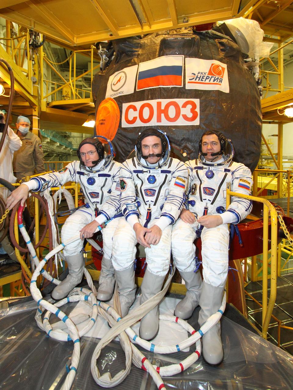 At the Baikonur Cosmodrome in Kazakhstan, Expedition 25 Flight Engineers Scott Kelly of NASA, Alexander Kaleri and Oleg Skripochka (left to right) take a moment to pose for pictures in front of their Soyuz TMA-01M spacecraft during a training and Soyuz inspection exercise September 26, 2010 as they prepare for launch October 8 to the International Space Station.  Credit: NASA/Victor Zelentsov 