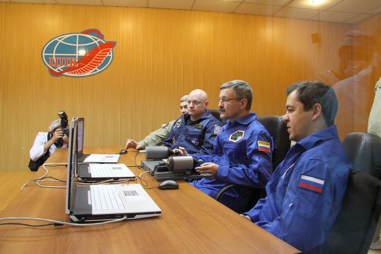 At their crew quarters in Baikonur, Kazakhstan, Expedition 25 Flight Engineers Scott Kelly of NASA (left), Alexander Kaleri (center) and Oleg Skripochka review rendezvous and docking programs on a laptop simulator October 2, 2010 as they prepare for their launch October 8 in the Soyuz TMA-01M spacecraft to the International Space Station.  Credit: NASA/Victor Zelentsov 
