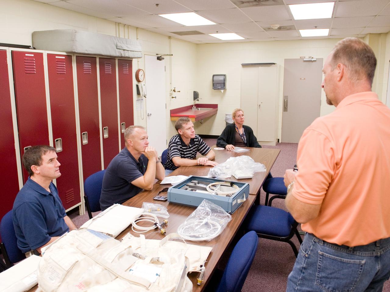 JSC2010-E-170899 (1 Oct. 2010) --- United Space Alliance crew trainer Robert (Rob) Tomaro (right) briefs STS-135 crew members during a training session in the Space Vehicle Mock-up Facility at NASA's Johnson Space Center. Seated from the left are NASA astronauts Rex Walheim, mission specialist; Doug Hurley, pilot; Chris Ferguson, commander; and Sandy Magnus, mission specialist. STS-135 is planned to be the final mission of the space shuttle program. Photo credit: NASA or National Aeronautics and Space Administration
