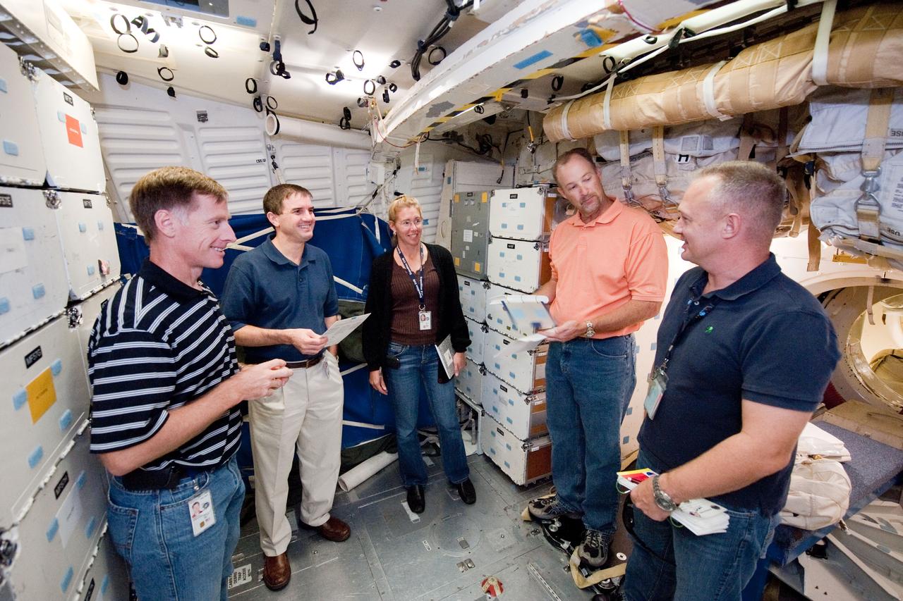 JSC2010-E-170901 (1 Oct. 2010) --- NASA astronauts Chris Ferguson (left), STS-135 commander; Rex Walheim, Sandy Magnus, both mission specialists; and Doug Hurley (right foreground), pilot, participate in a training session on the middeck of the crew compartment trainer (CCT-2) in the Space Vehicle Mock-up Facility at NASA's Johnson Space Center. United Space Alliance crew trainer Robert (Rob) Tomaro (second right) assisted the crew members. STS-135 is planned to be the final mission of the space shuttle program. Photo credit: NASA or National Aeronautics and Space Administration