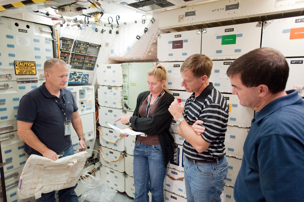 JSC2010-E-170906 (1 Oct. 2010) --- NASA astronauts Chris Ferguson (second right), STS-135 commander; Doug Hurley (left), pilot; Sandy Magnus and Rex Walheim, both mission specialists, participate in a training session on the middeck of the crew compartment trainer (CCT-2) in the Space Vehicle Mock-up Facility at NASA's Johnson Space Center. STS-135 is planned to be the final mission of the space shuttle program. Photo credit: NASA or National Aeronautics and Space Administration