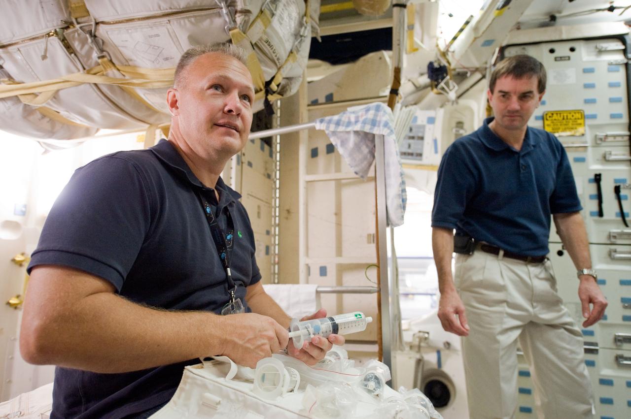 JSC2010-E-170908 (1 Oct. 2010) --- NASA astronauts Doug Hurley (left), STS-135 pilot; and Rex Walheim, mission specialist, participate in a training session on the middeck of the crew compartment trainer (CCT-2) in the Space Vehicle Mock-up Facility at NASA's Johnson Space Center. STS-135 is planned to be the final mission of the space shuttle program. Photo credit: NASA or National Aeronautics and Space Administration