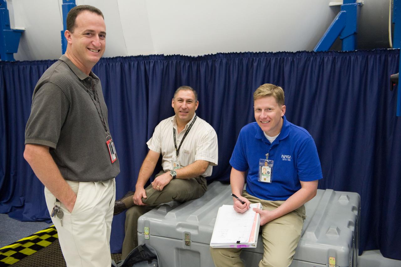JSC2010-E-171240 (30 Sept. 2010) --- Crew instructors Steven Berenzweig (left), Raul Tijerina (center) and Gary Kilgo are pictured during an STS-133 ingress/egress timeline training session in the Space Vehicle Mock-up Facility at NASA's Johnson Space Center. Photo credit: NASA or National Aeronautics and Space Administration
