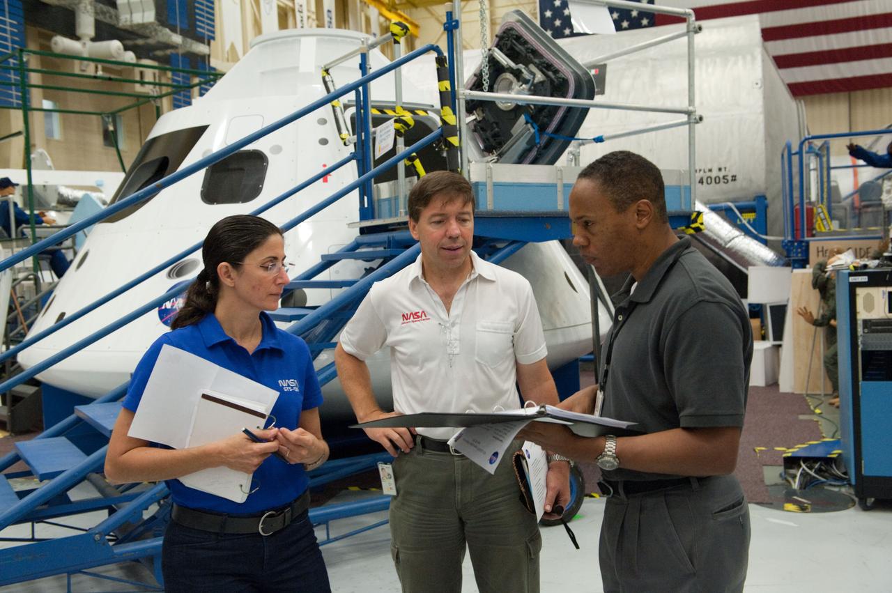 JSC2010-E-171243 (30 Sept. 2010) --- NASA astronauts Nicole Stott, Michael Barratt (center) and Alvin Drew, all STS-133 mission specialists, participate in an ingress/egress timeline training session in the Space Vehicle Mock-up Facility at NASA's Johnson Space Center. Photo credit: NASA or National Aeronautics and Space Administration