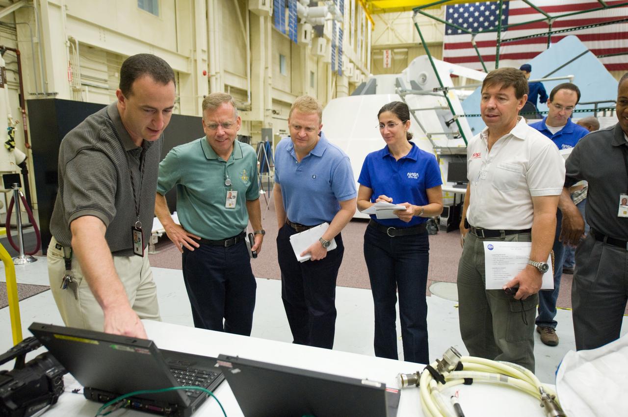 JSC2010-E-171246 (30 Sept. 2010) --- NASA astronauts Steve Lindsey (second left), STS-133 commander; and Eric Boe, pilot; along with Nicole Stott, Michael Barratt and Alvin Drew (partially out of frame at right), all mission specialists, participate in an ingress/egress timeline training session in the Space Vehicle Mock-up Facility at NASA's Johnson Space Center. Crew instructor Steven Berenzweig (left) assisted the crew members. Photo credit: NASA or National Aeronautics and Space Administration