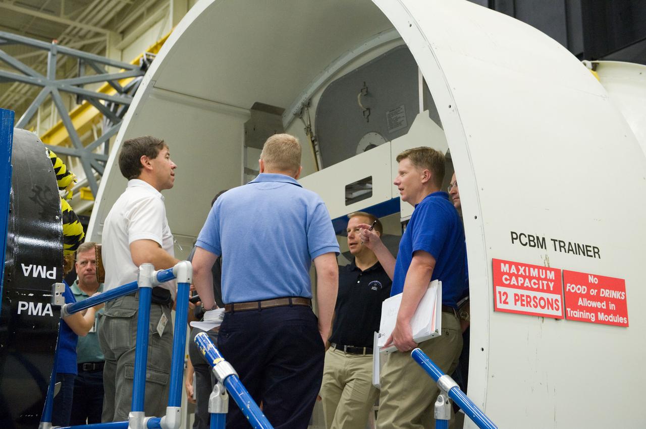 JSC2010-E-171438 (30 Sept. 2010) --- NASA astronauts Steve Lindsey (left background), STS-133 commander; Eric Boe (back to camera), pilot; Michael Barratt (left), Tim Kopra and Alvin Drew (mostly obscured at center), all mission specialists, participate in an ingress/egress timeline training session in the Space Vehicle Mock-up Facility at NASA's Johnson Space Center. Crew instructor Gary W. Kilgo (right) assisted the crew members. Photo credit: NASA or National Aeronautics and Space Administration