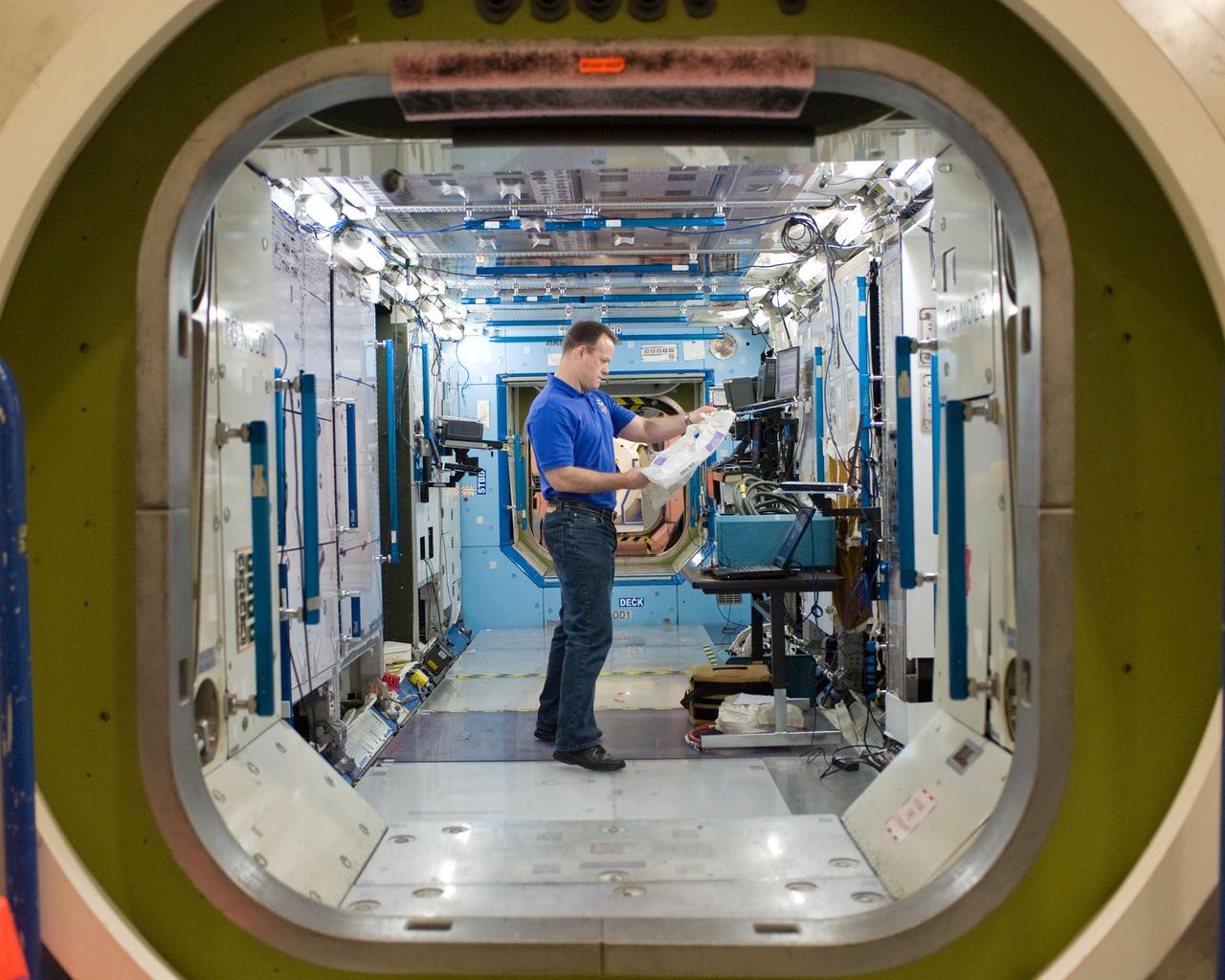 PHOTO DATE:  10-28-10 LOCATION:  Bldg 9NW, ISS Mockups SUBJECT:  Expedition 27 crew members Ron Garan, Andre Borisenko and Aleksandr Samokutyayev all working with instructors Nadine Lashier and Jennifer James during the crew's Routine Ops training PHOTOGRAPHER: James Blair 
