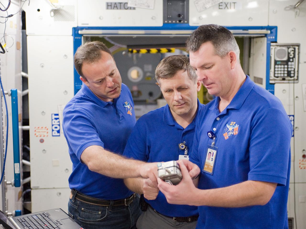 PHOTO DATE:  10-28-10 LOCATION:  Bldg 9NW, ISS Mockups SUBJECT:  Expedition 27 crew members Ron Garan, Andre Borisenko and Aleksandr Samokutyayev all working with instructors Nadine Lashier and Jennifer James during the crew's Routine Ops training PHOTOGRAPHER: James Blair 