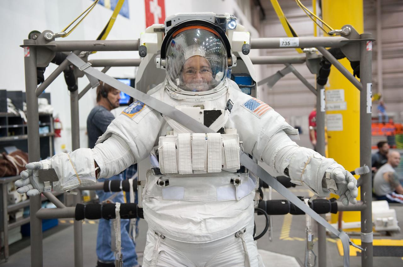 JSC2010-E-181461 (27 Oct. 2010) --- Attired in a training version of her Extravehicular Mobility Unit (EMU) spacesuit, NASA astronaut Sandy Magnus, STS-135 mission specialist, is about to be submerged in the waters of the Neutral Buoyancy Laboratory (NBL) near NASA's Johnson Space Center. Divers (out of frame) are in the water to assist Magnus in her rehearsal, which is intended to help prepare her for work on the exterior of the International Space Station. STS-135 is planned to be the final mission of the space shuttle program. Photo credit: NASA or National Aeronautics and Space Administration