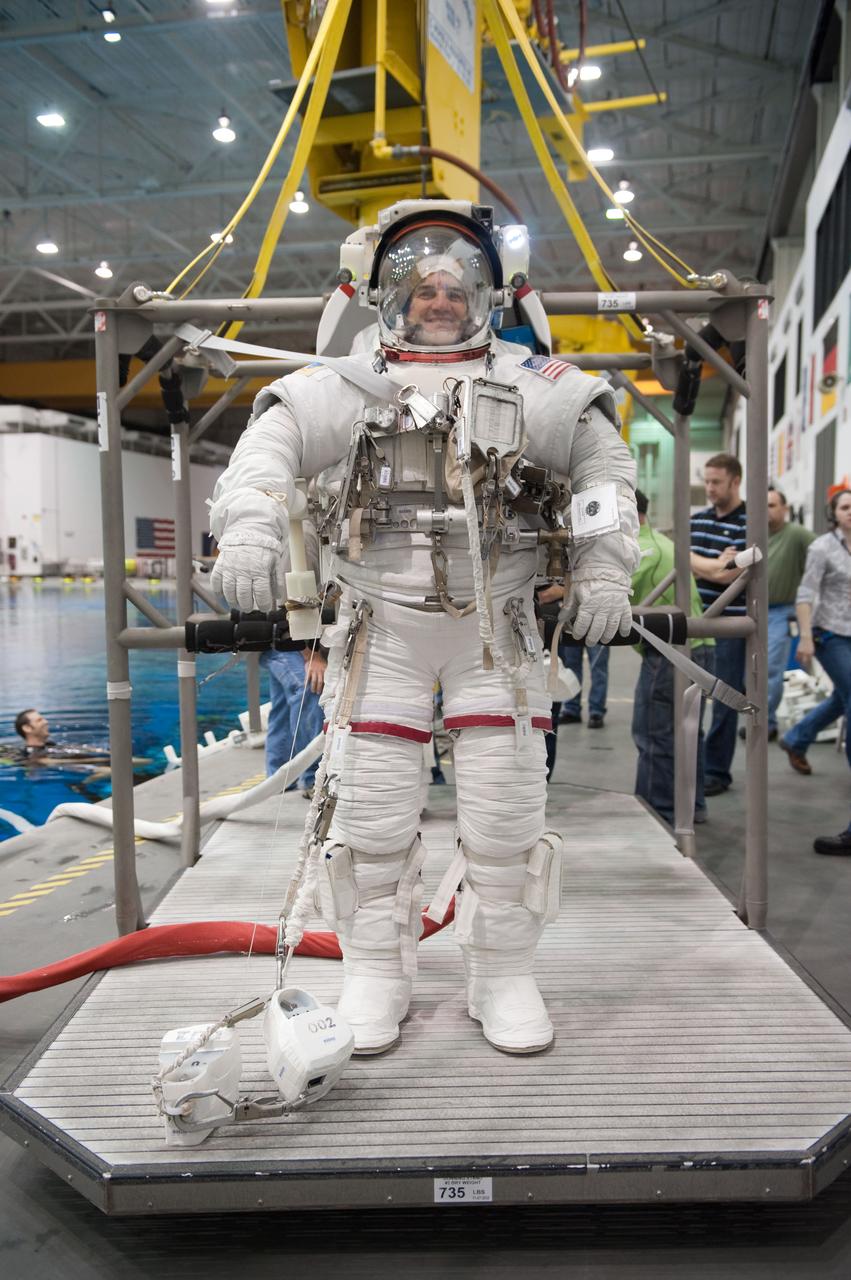 JSC2010-E-181470 (27 Oct. 2010) --- Attired in a training version of his Extravehicular Mobility Unit (EMU) spacesuit, NASA astronaut Rex Walheim, STS-135 mission specialist, is about to be submerged in the waters of the Neutral Buoyancy Laboratory (NBL) near NASA's Johnson Space Center. Divers (out of frame) are in the water to assist Walheim in his rehearsal, which is intended to help prepare him for work on the exterior of the International Space Station. STS-135 is planned to be the final mission of the space shuttle program. Photo credit: NASA or National Aeronautics and Space Administration