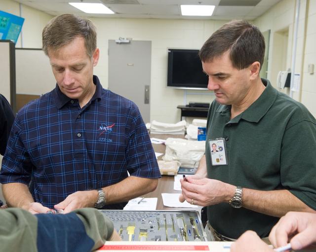 NASA image: STS-335 crew training, Tool/Repair Kits with instructor Jeff Stone   