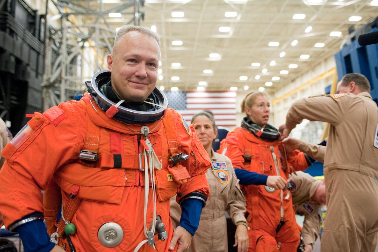 JSC2010-E-183253 (4 Nov. 2010) --- NASA astronaut Doug Hurley, STS-135 pilot, attired in a training version of his shuttle launch and entry suit, awaits the start of a training session in the Space Vehicle Mock-up Facility at NASA's Johnson Space Center. NASA astronaut Sandy Magnus, mission specialist, is visible in the background. STS-135 is planned to be the final mission of the space shuttle program. Photo credit: NASA or National Aeronautics and Space Administration