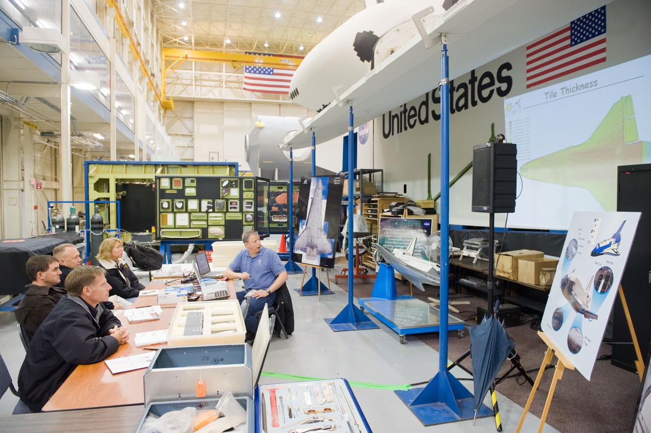 JSC2010-E-183512 (3 Nov. 2010) --- STS-135 crew members participate in an EVA Thermal Protection System (TPS) overview training session in the TPS/ Precision Air Bearing Facility in the Space Vehicle Mock-up Facility at NASA's Johnson Space Center. Pictured from the left are NASA astronauts Chris Ferguson, commander; Rex Walheim, mission specialist; Doug Hurley, pilot; and Sandy Magnus, mission specialist. John Ray (right) assisted the crew members. STS-135 is planned to be the final mission of the space shuttle program. Photo credit: NASA or National Aeronautics and Space Administration