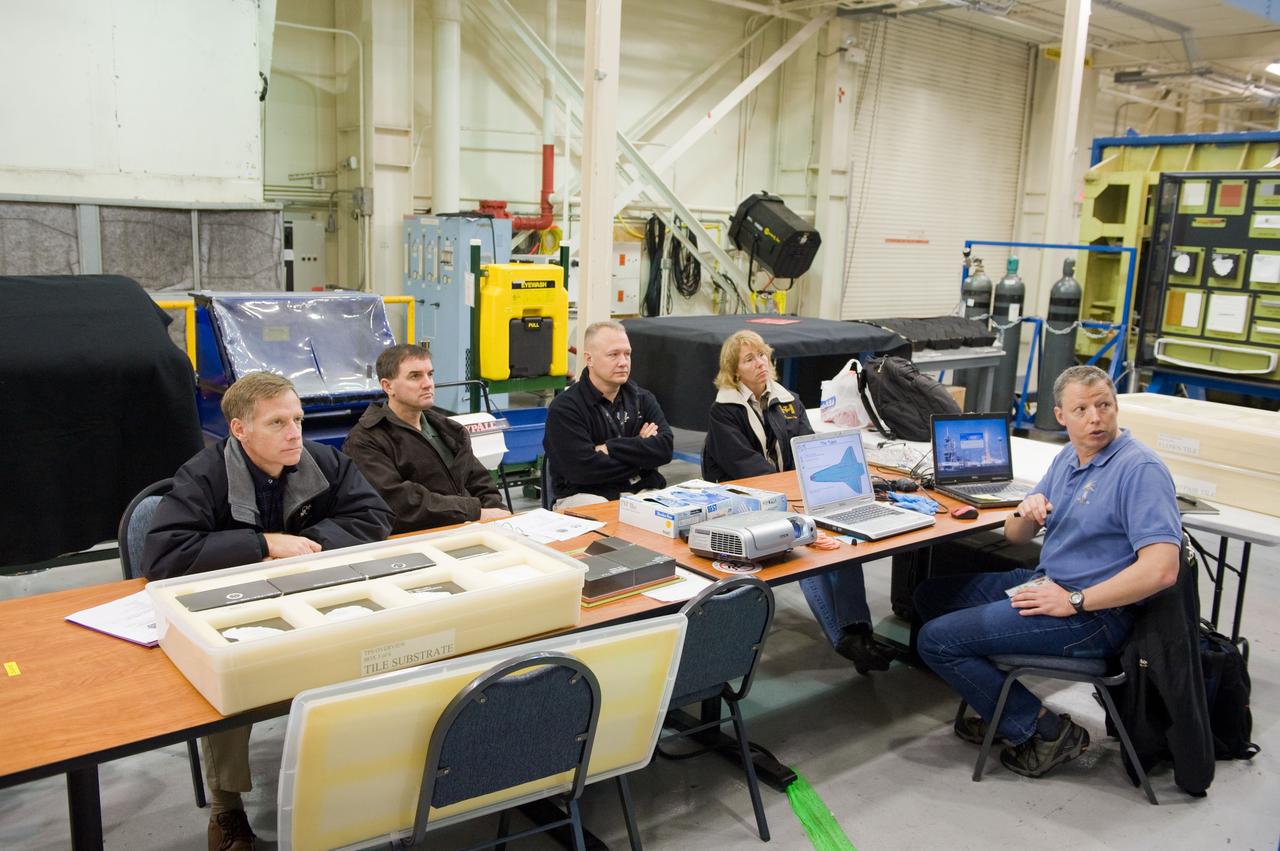 JSC2010-E-183513 (3 Nov. 2010) --- STS-135 crew members participate in an EVA Thermal Protection System (TPS) overview training session in the TPS/ Precision Air Bearing Facility in the Space Vehicle Mock-up Facility at NASA's Johnson Space Center. Pictured from the left are NASA astronauts Chris Ferguson, commander; Rex Walheim, mission specialist; Doug Hurley, pilot; and Sandy Magnus, mission specialist. John Ray (right) assisted the crew members. STS-135 is planned to be the final mission of the space shuttle program. Photo credit: NASA or National Aeronautics and Space Administration