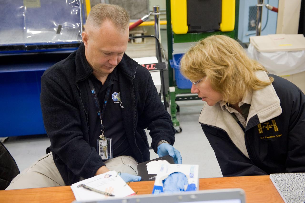 JSC2010-E-183519 (3 Nov. 2010) --- NASA astronauts Doug Hurley, STS-135 pilot; and Sandy Magnus, mission specialist, participate in an EVA Thermal Protection System (TPS) overview training session in the TPS/ Precision Air Bearing Facility in the Space Vehicle Mock-up Facility at NASA's Johnson Space Center. STS-135 is planned to be the final mission of the space shuttle program. Photo credit: NASA or National Aeronautics and Space Administration