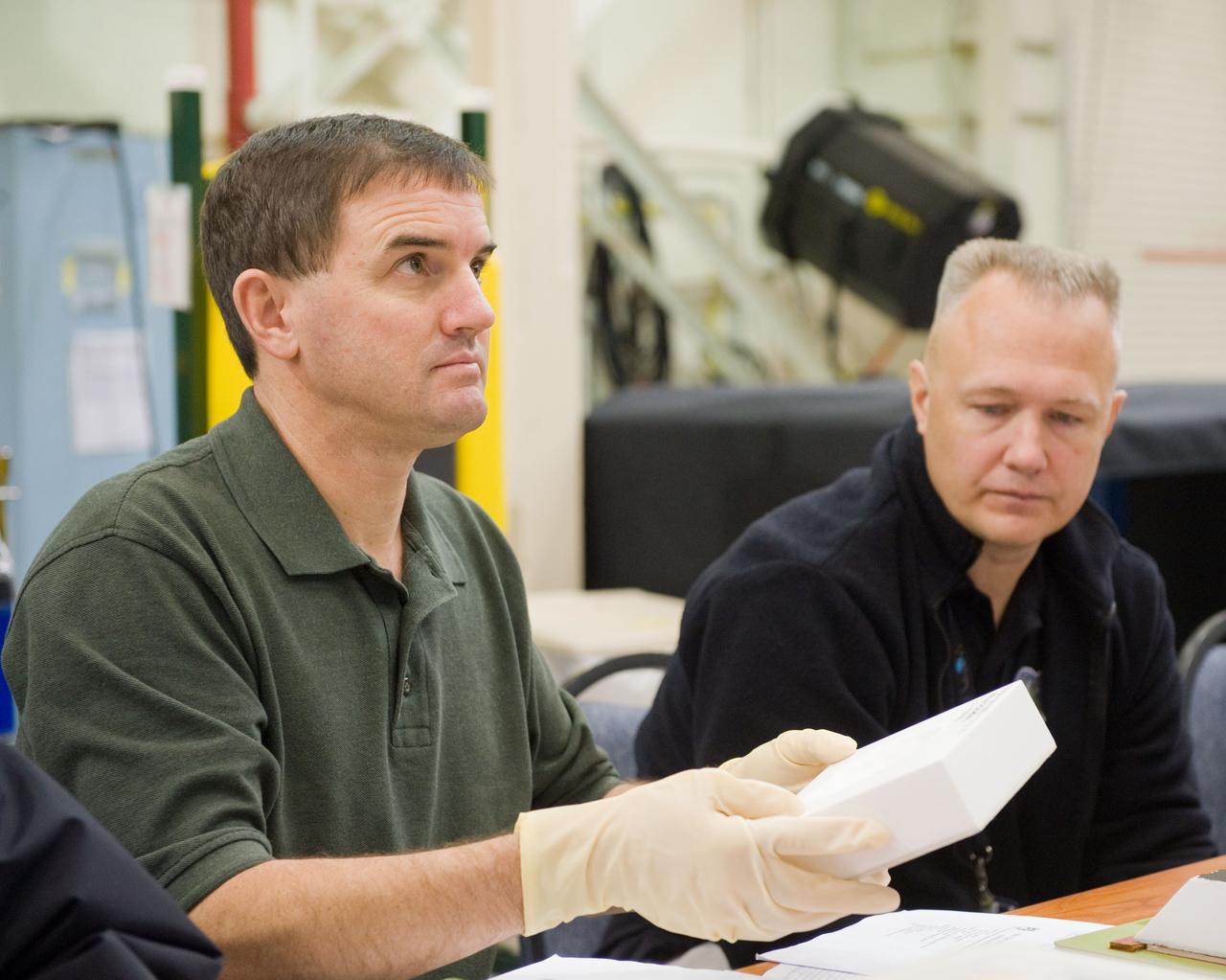 JSC2010-E-183523 (3 Nov. 2010) --- NASA astronauts Rex Walheim (left), STS-135 mission specialist; and Doug Hurley, pilot, participate in an EVA Thermal Protection System (TPS) overview training session in the TPS/ Precision Air Bearing Facility in the Space Vehicle Mock-up Facility at NASA's Johnson Space Center. STS-135 is planned to be the final mission of the space shuttle program. Photo credit: NASA or National Aeronautics and Space Administration