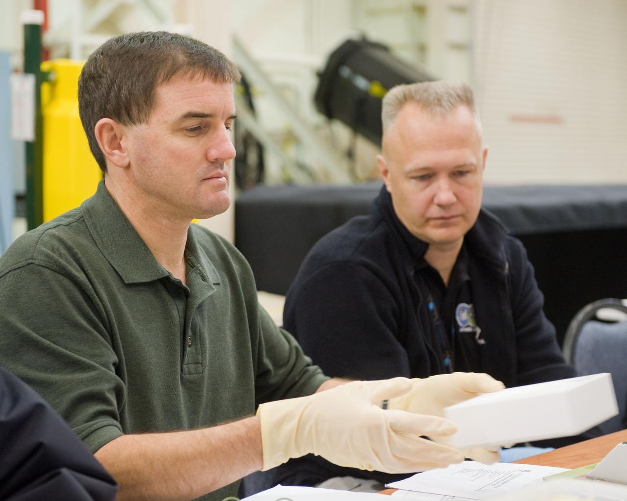 JSC2010-E-183524 (3 Nov. 2010) --- NASA astronauts Rex Walheim (left), STS-135 mission specialist; and Doug Hurley, pilot, participate in an EVA Thermal Protection System (TPS) overview training session in the TPS/ Precision Air Bearing Facility in the Space Vehicle Mock-up Facility at NASA's Johnson Space Center. STS-135 is planned to be the final mission of the space shuttle program. Photo credit: NASA or National Aeronautics and Space Administration