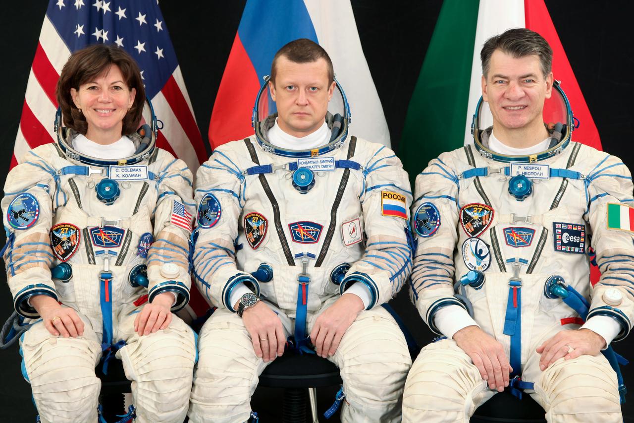 JSC2010-E-185682 (8 Nov. 2010) --- Attired in Russian Sokol launch and entry suits, Russian cosmonaut Dmitry Kondratyev (center), Expedition 26 flight engineer and Expedition 27 commander; along with NASA astronaut Catherine Coleman and European Space Agency (ESA) astronaut Paolo Nespoli, both Expedition 26/27 flight engineers, take a break from training in Star City, Russia to pose for a portrait. Photo credit: Gagarin Cosmonaut Training Center