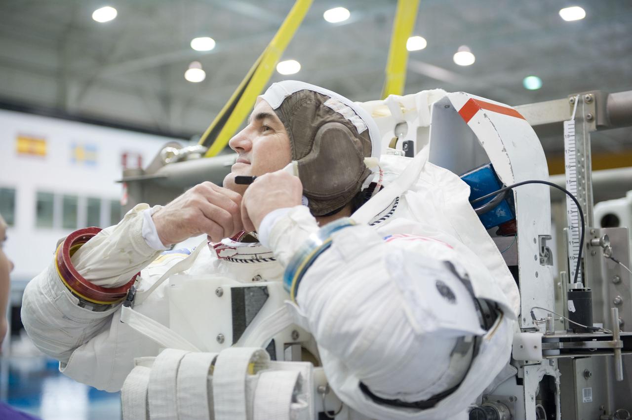 JSC2010-E-187202 (22 Nov. 2010) --- NASA astronaut Rex Walheim, STS-135 mission specialist, dons a training version of his Extravehicular Mobility Unit (EMU) spacesuit in preparation for a spacewalk training session in the waters of the Neutral Buoyancy Laboratory (NBL) near NASA's Johnson Space Center. STS-135 is planned to be the final mission of the space shuttle program. Photo credit: NASA or National Aeronautics and Space Administration