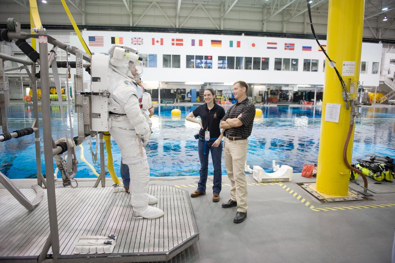 JSC2010-E-187220 (22 Nov. 2010) --- NASA astronaut Ron Garan, Expedition 27/28 flight engineer, attired in a training version of his Extravehicular Mobility Unit (EMU) spacesuit, awaits the start of a spacewalk training session in the waters of the Neutral Buoyancy Laboratory (NBL) near NASA's Johnson Space Center. NASA astronaut Chris Ferguson, STS-135 commander, is at right. Photo credit: NASA or National Aeronautics and Space Administration