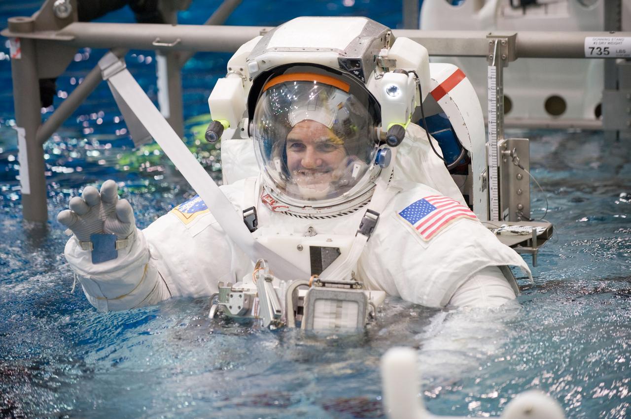 JSC2010-E-187233 (22 Nov. 2010) --- Attired in a training version of his Extravehicular Mobility Unit (EMU) spacesuit, NASA astronaut Rex Walheim, STS-135 mission specialist, is submerged in the waters of the Neutral Buoyancy Laboratory (NBL) near NASA's Johnson Space Center. Divers (out of frame) are in the water to assist Walheim in his rehearsal, which is intended to help prepare him for work on the exterior of the International Space Station. STS-135 is planned to be the final mission of the space shuttle program. Photo credit: NASA or National Aeronautics and Space Administration
