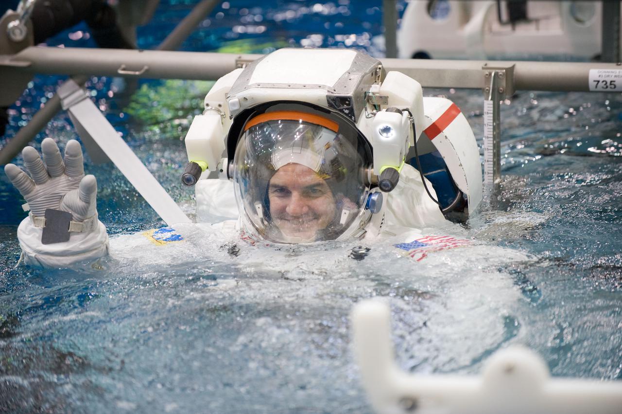 JSC2010-E-187234 (22 Nov. 2010) --- Attired in a training version of his Extravehicular Mobility Unit (EMU) spacesuit, NASA astronaut Rex Walheim, STS-135 mission specialist, is submerged in the waters of the Neutral Buoyancy Laboratory (NBL) near NASA's Johnson Space Center. Divers (out of frame) are in the water to assist Walheim in his rehearsal, which is intended to help prepare him for work on the exterior of the International Space Station. STS-135 is planned to be the final mission of the space shuttle program. Photo credit: NASA or National Aeronautics and Space Administration