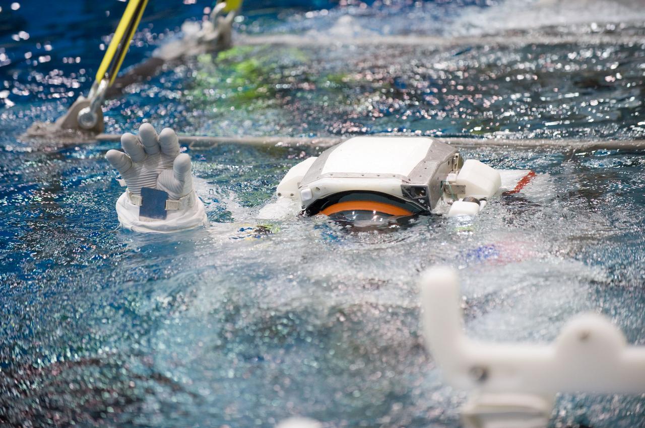 JSC2010-E-187235 (22 Nov. 2010) --- Attired in a training version of his Extravehicular Mobility Unit (EMU) spacesuit, NASA astronaut Rex Walheim, STS-135 mission specialist, is submerged in the waters of the Neutral Buoyancy Laboratory (NBL) near NASA's Johnson Space Center. Divers (out of frame) are in the water to assist Walheim in his rehearsal, which is intended to help prepare him for work on the exterior of the International Space Station. STS-135 is planned to be the final mission of the space shuttle program. Photo credit: NASA or National Aeronautics and Space Administration