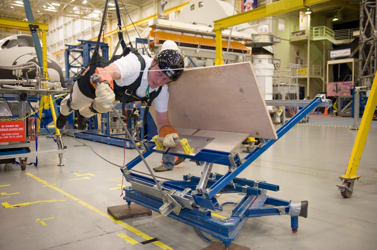 JSC2010-E-193872 (1 Dec. 2010) --- NASA astronaut Michael Fincke, STS-134 mission specialist, participates in an extravehicular activity (EVA) training session in the Partial Gravity Simulator (POGO) test area in the Space Vehicle Mock-up Facility at NASA?s Johnson Space Center. Photo credit: NASA or National Aeronautics and Space Administration