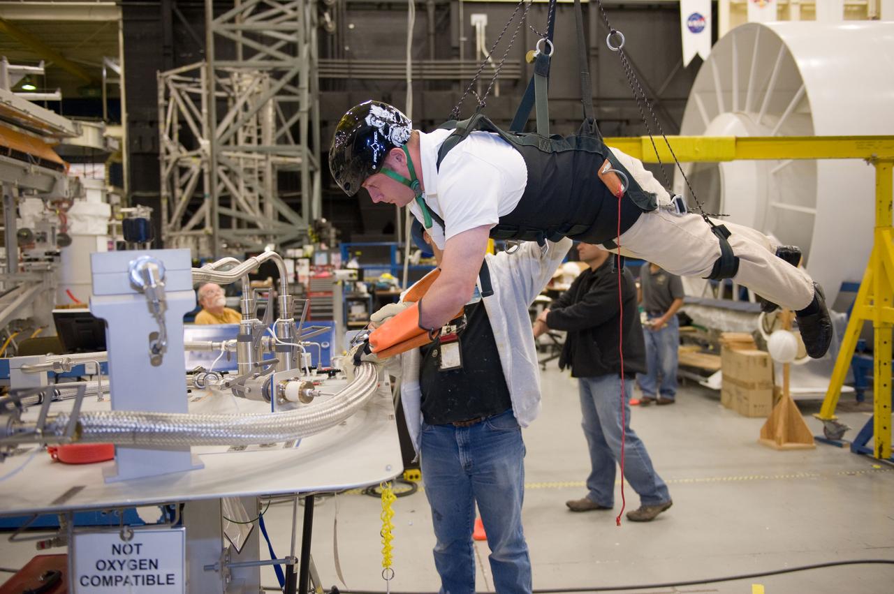 JSC2010-E-193879 (1 Dec. 2010) --- NASA astronaut Michael Fincke, STS-134 mission specialist, participates in an extravehicular activity (EVA) training session in the Partial Gravity Simulator (POGO) test area in the Space Vehicle Mock-up Facility at NASA?s Johnson Space Center. Photo credit: NASA or National Aeronautics and Space Administration