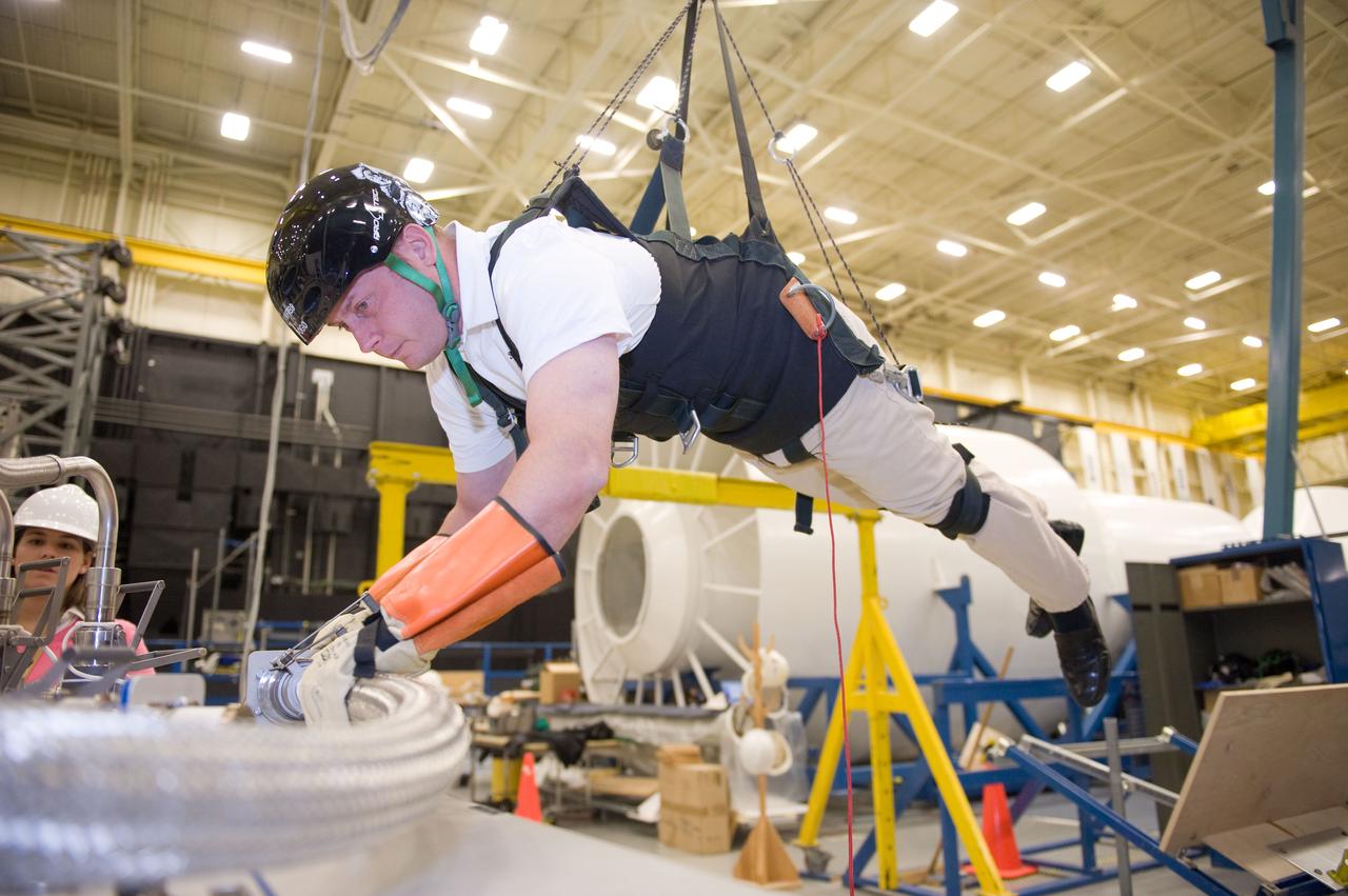 JSC2010-E-193881 (1 Dec. 2010) --- NASA astronaut Michael Fincke, STS-134 mission specialist, participates in an extravehicular activity (EVA) training session in the Partial Gravity Simulator (POGO) test area in the Space Vehicle Mock-up Facility at NASA?s Johnson Space Center. Photo credit: NASA or National Aeronautics and Space Administration
