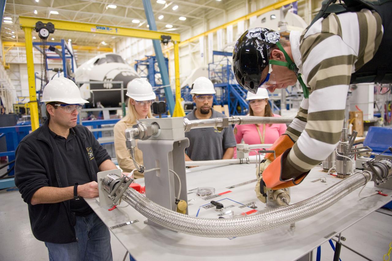 JSC2010-E-193900 (1 Dec. 2010) --- NASA astronaut Andrew Feustel (right), STS-134 mission specialist, participates in an extravehicular activity (EVA) training session in the Partial Gravity Simulator (POGO) test area in the Space Vehicle Mock-up Facility at NASA?s Johnson Space Center. NASA astronaut Greg Chamitoff (left), mission specialist, looks on. Photo credit: NASA or National Aeronautics and Space Administration