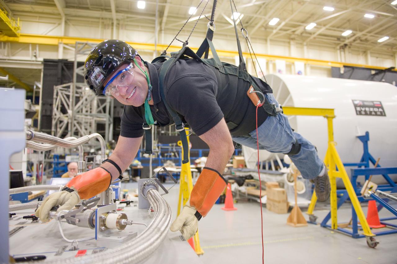 JSC2010-E-193910 (1 Dec. 2010) --- NASA astronaut Greg Chamitoff, STS-134 mission specialist, participates in an extravehicular activity (EVA) training session in the Partial Gravity Simulator (POGO) test area in the Space Vehicle Mock-up Facility at NASA?s Johnson Space Center. Photo credit: NASA or National Aeronautics and Space Administration