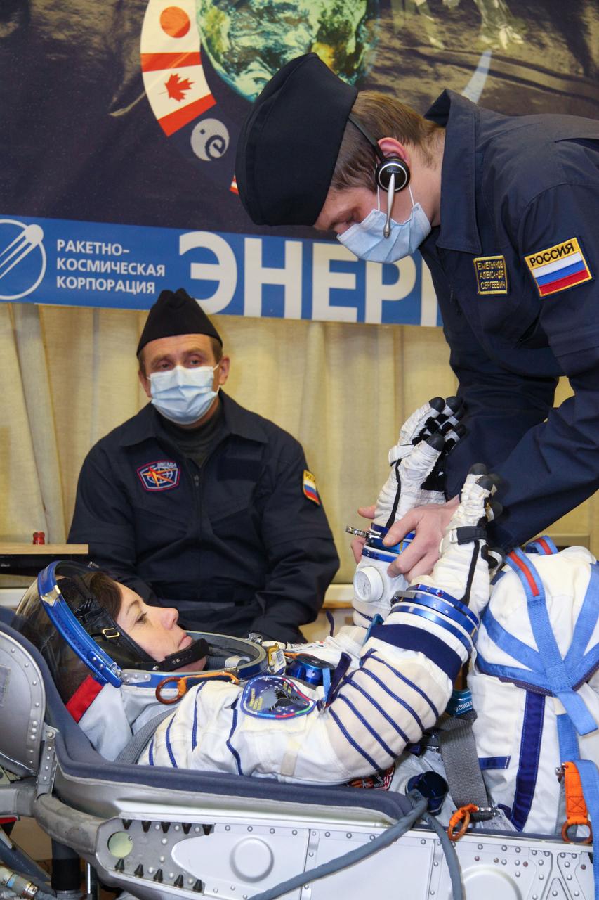 At the Baikonur Cosmodrome in Kazakhstan, Expedition 26 Flight Engineer Catherine Coleman of NASA undergoes a pressure and leak check of her Russian Sokol launch and entry suit December 4, 2010 prior to a fit check in the Soyuz TMA-20 spacecraft she, Soyuz Commander Dmitry Kondratyev and Flight Engineer Paolo Nespoli of the European Space Agency will launch in December 16 (Baikonur time) to the International Space Station. Credit: NASA/Victor Zelentsov