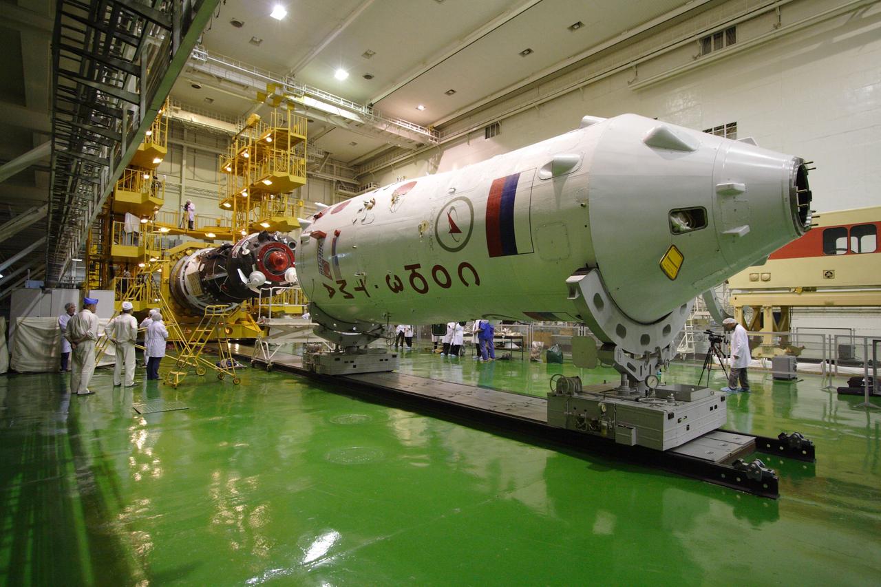 (9 Dec. 2010) --- At the Baikonur Cosmodrome in Kazakhstan, the Soyuz TMA-20 spacecraft (left) is prepared for integration into its payload fairing (right) on Dec. 9, 2010. The vehicle is set to launch Dec. 16 (Kazakhstan time) to deliver NASA astronaut Catherine (Cady) Coleman, Expedition 26 flight engineer; Soyuz commander Dmitry Kondratyev of Russia's Federal Space Agency (Roscosmos) and European Space Agency astronaut Paolo Nespoli, flight engineer, to the International Space Station. Photo credit: NASA/Victor Zelentsov