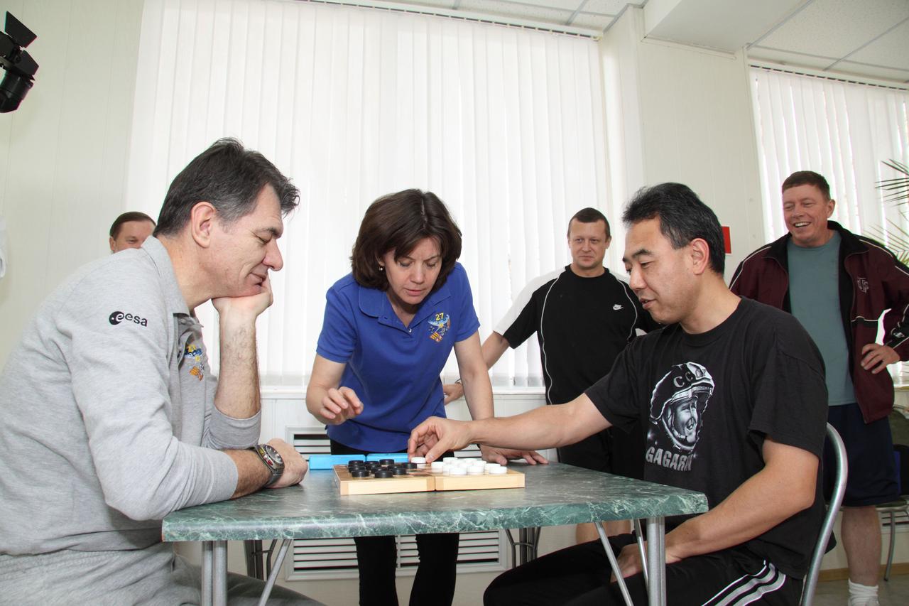 JSC2010-E-195167 (10 Dec. 2010) --- At the Cosmonaut Hotel in Kazakhstan, European Space Agency astronaut Paolo Nespoli, Expedition 26 flight engineer (from left), NASA astronaut Catherine (Cady) Coleman, Expedition 26 flight engineer; and Japan Aerospace Exploration Agency astronaut Satoshi Furukawa take part in recreational activities while Soyuz commander Dmitry Kondratyev of Russia's Federal Space Agency (Roscosmos) looks on. Nespoli, Coleman and Kondratyev will launch Dec. 16 (Kazakhstan time) to the International Space Station. Photo credit: NASA/Victor Zelentsov