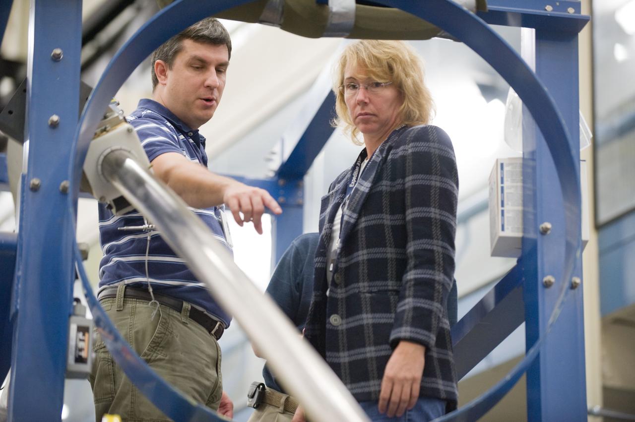 JSC2010-E-195522 (3 Dec. 2010) --- NASA astronaut Sandy Magnus, STS-135 mission specialist, participates in an emergency egress training session in the Space Vehicle Mock-up Facility at NASA's Johnson Space Center. Crew instructor Patrick Jones assisted Magnus. STS-135 is planned to be the final mission of the space shuttle program. Photo credit: NASA or National Aeronautics and Space Administration