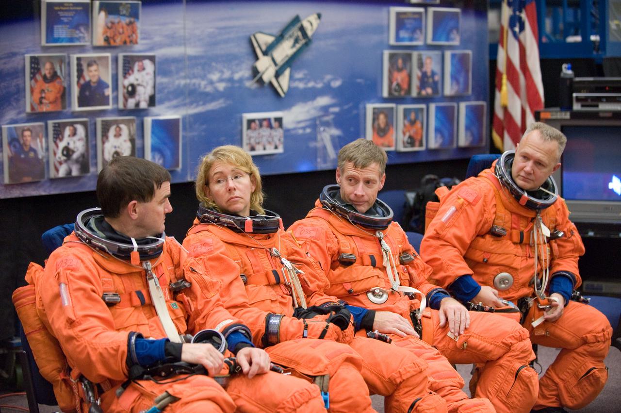 JSC2010-E-195550 (3 Dec. 2010) --- Attired in training versions of their shuttle launch and entry suits, STS-135 crew members await the start of a training session in the Space Vehicle Mock-up Facility at NASA's Johnson Space Center. Pictured from the left are NASA astronauts Rex Walheim, Sandy Magnus, both mission specialists; Chris Ferguson, commander; and Doug Hurley, pilot. STS-135 is planned to be the final mission of the space shuttle program. Photo credit: NASA or National Aeronautics and Space Administration