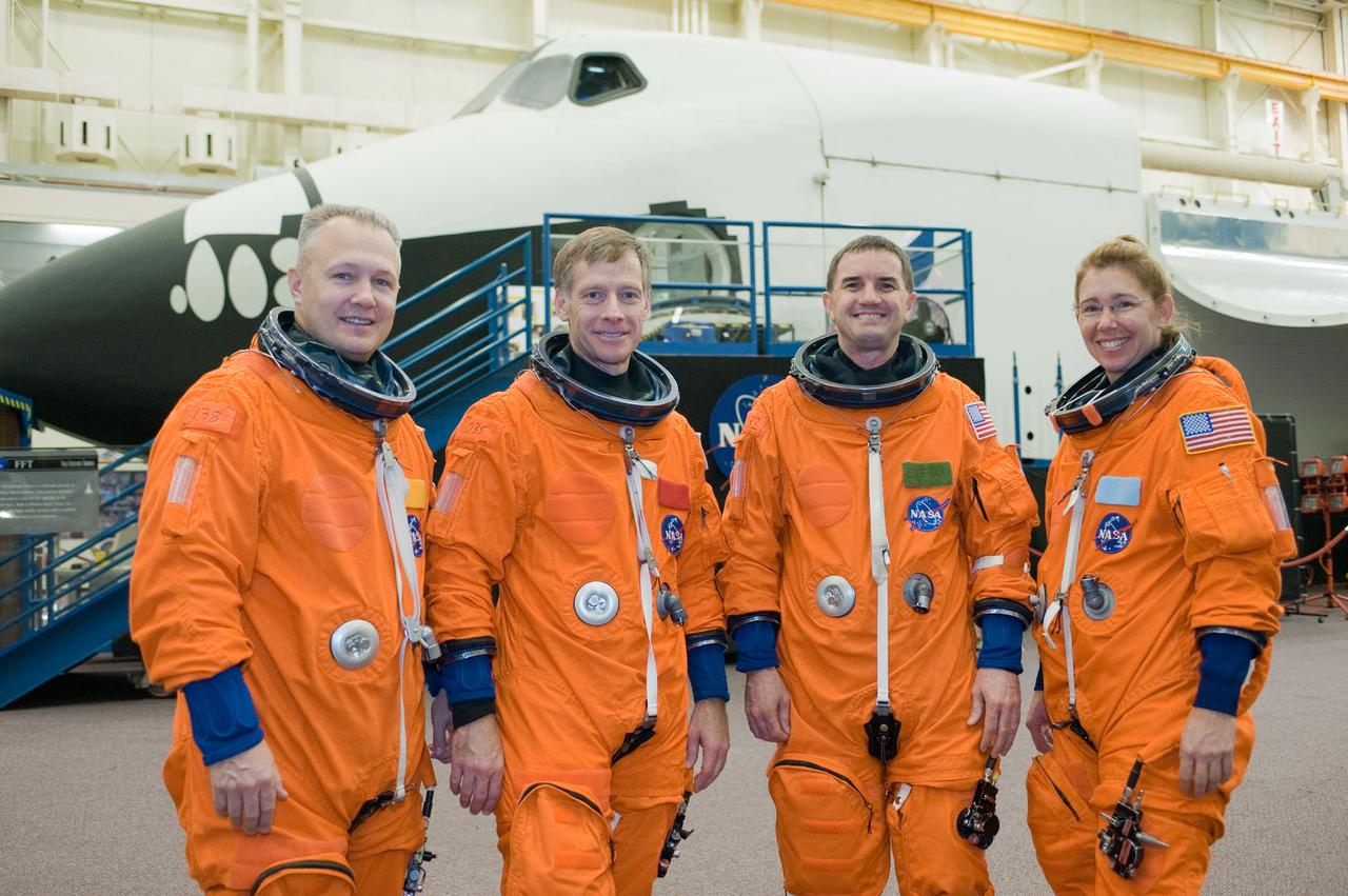 JSC2010-E-196887 (20 Dec. 2010) --- Attired in training versions of their shuttle launch and entry suits, the STS-135 crew members take a brief break for a portrait in the Space Vehicle Mock-up Facility at NASA's Johnson Space Center. From the left are NASA astronauts Doug Hurley, pilot; Chris Ferguson, commander; Rex Walheim and Sandy Magnus, both mission specialists. STS-135 is planned to be the final mission of the space shuttle program. Photo credit: NASA or National Aeronautics and Space Administration